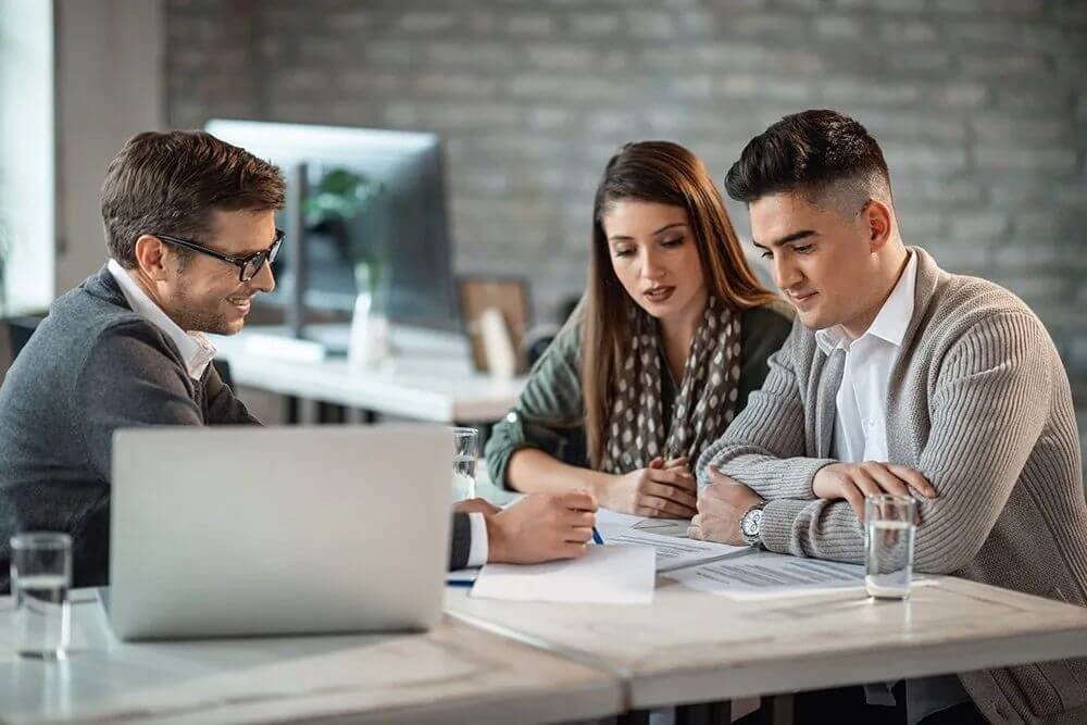 People reviewing documents on a desk