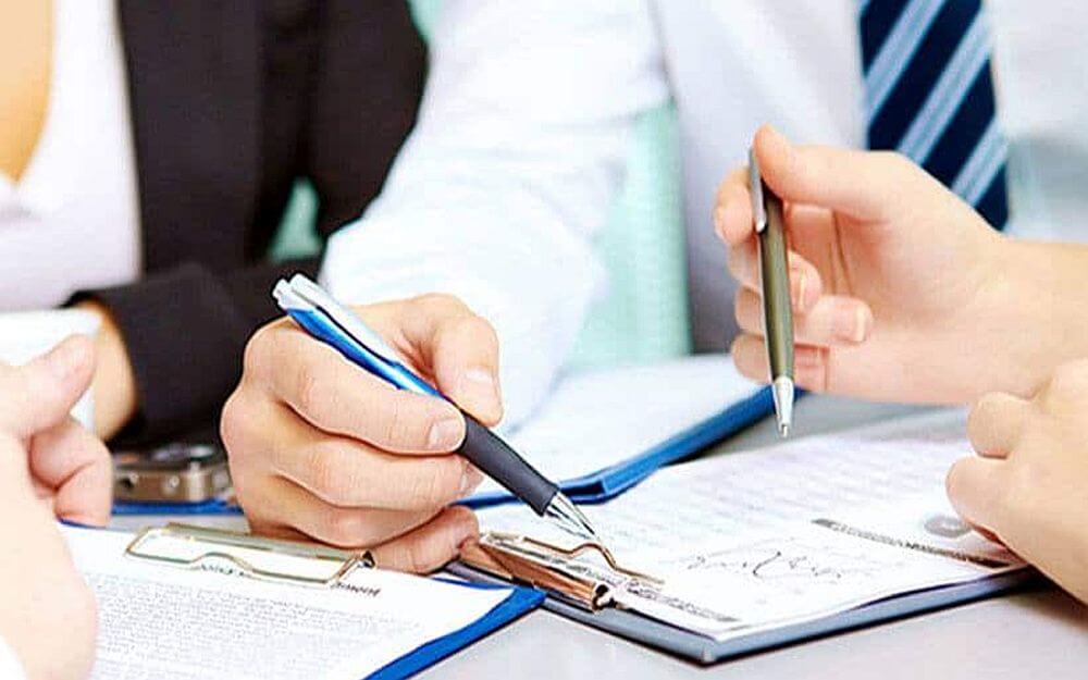People working on clipboard on a desk